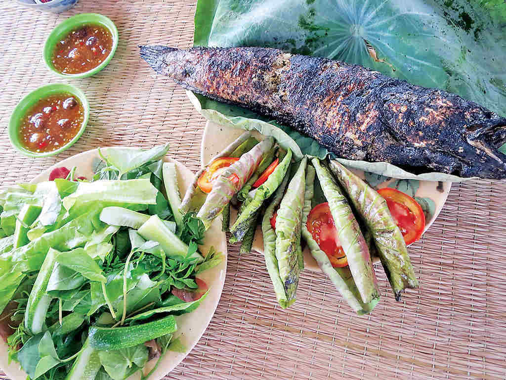 grilled snakehead fish rolled in lotus leaf