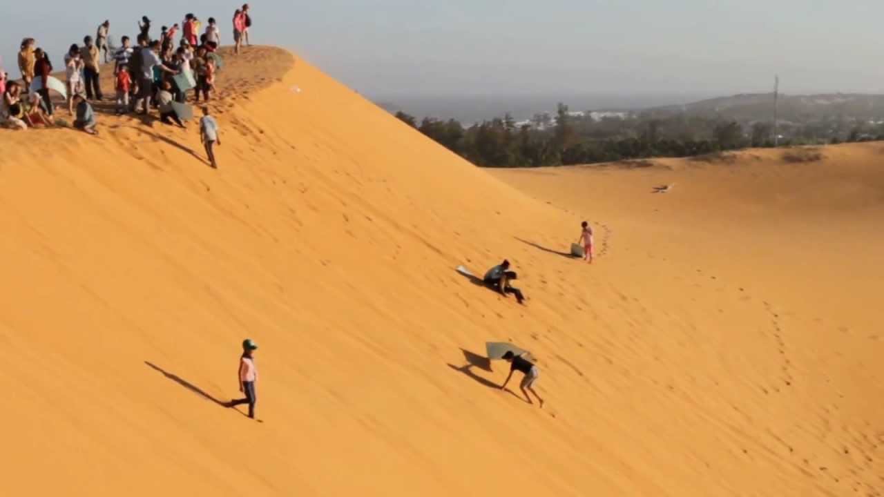 Picture/Photo: Woman on top of red sand dunes. Mui Ne, Vietnam